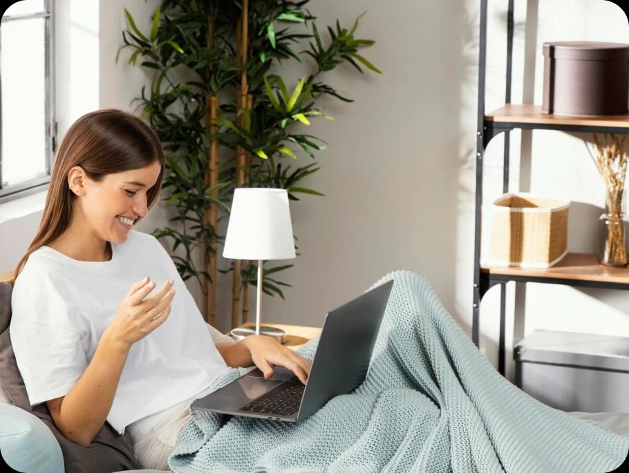 Woman smiling and looking at her macbook screen